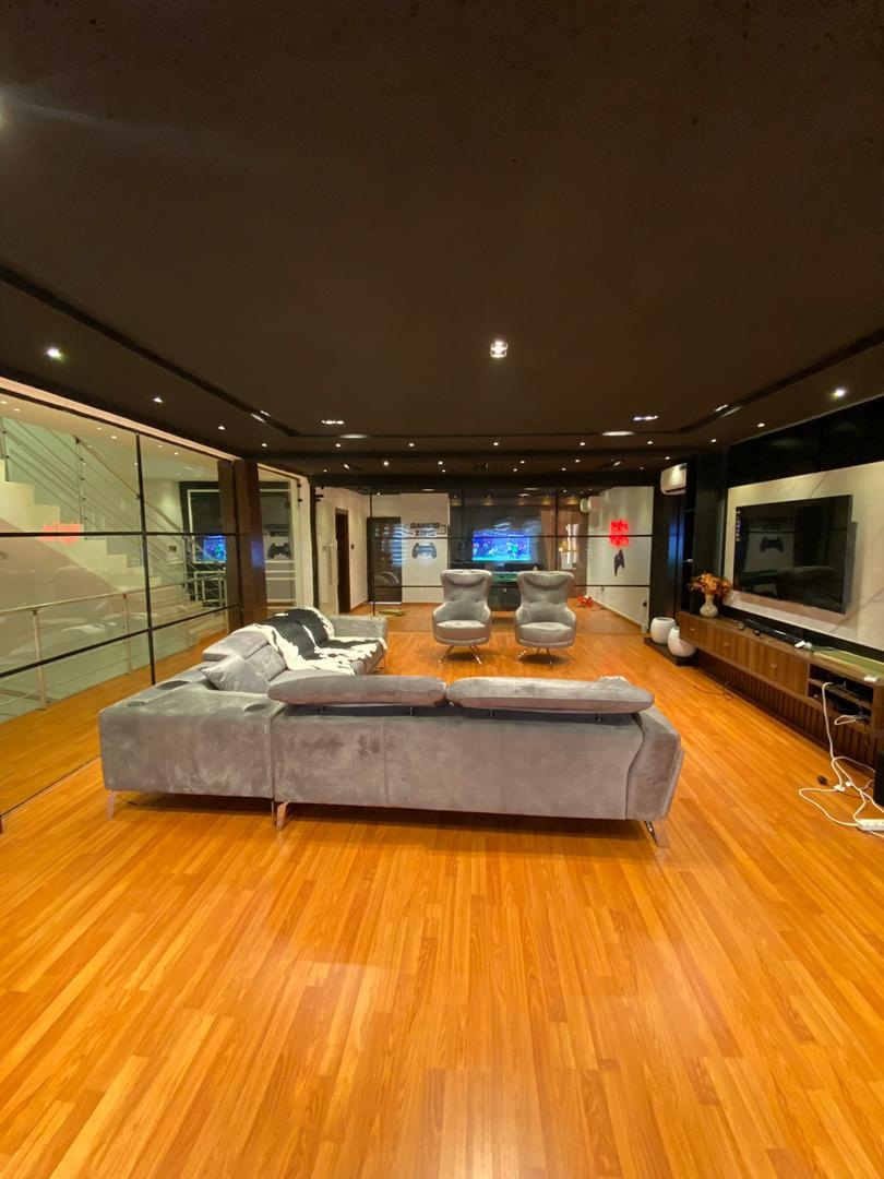 Project Sapphire lounge with grey sectional and glass partitions