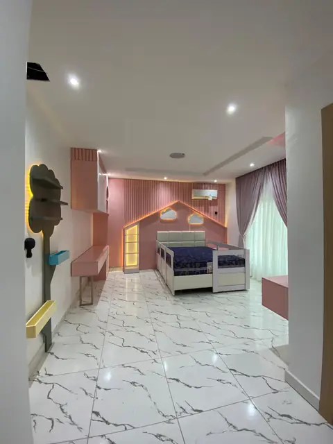 Pink bedroom seen from the hallway with marble flooring